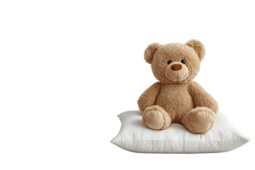 Sweet teddy bear sitting on a pillow against a white wall soft lighting minimalist setting