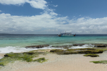 Obraz premium A small traditional fishing boat at the coast of Morotai island, North Maluku district, during bright sunny day