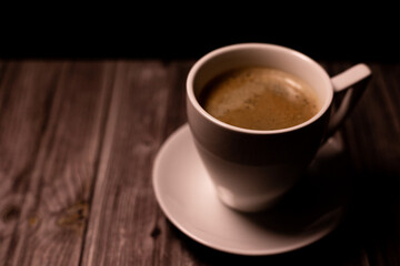 Fototapeta premium A cup of coffee on the table. A cup of coffee on a background. Coffee background