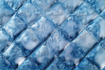 Fototapeta premium Textured Blue Quilted Fabric Close Up Diamond Pattern Soft Indigo Dye