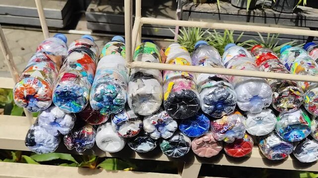 Colorful Plastic Bottle Ecobricks Filled with Non-Organic Waste for Creative Recycling Solution and Sustainable Household Waste Management

