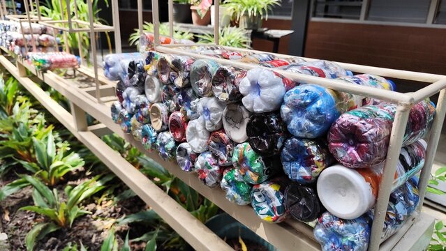 Colorful Plastic Bottle Ecobricks Filled with Non-Organic Waste for Creative Recycling Solution and Sustainable Household Waste Management

