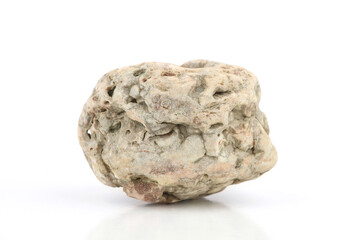 Weathered stone shaped by ocean  isolated on white background. Textured rock formed by natural elements.