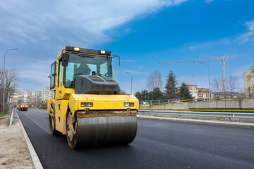 Road Construction with Asphalt Roller Compactor on Freshly Paved Street in Urban Area – Infrastructure Development and Civil Engineering Machinery
