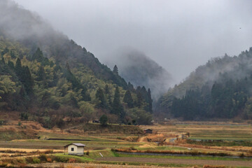 Fototapeta premium Misty Morning in a Quiet Mountain Valley in Rural Kyoto, Japan