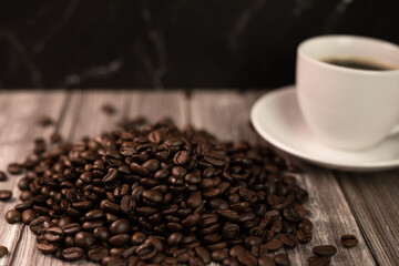 Espresso coffee and coffee beans on the table. Coffee in a white cup
