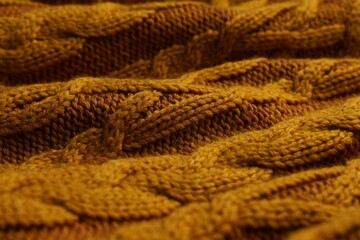 Orange knitted wool texture as background, closeup