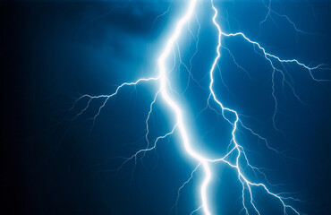 A bright white lightning bolt dramatically illuminates a dark blue stormy sky.  The powerful electrical discharge forks across the night atmosphere, showcasing nature's raw energy.