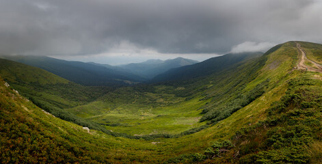 Panoramic view of the mountain range. Vacation in the mountains with a magnificent view. Valley high in the mountains.
