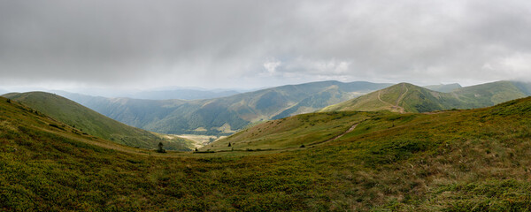 Panoramic view of the mountain range. Vacation in the mountains with a magnificent view. Valley high in the mountains.
