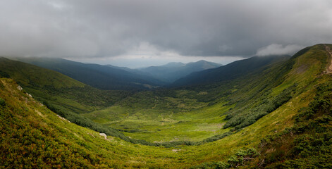 Panoramic view of the mountain range. Vacation in the mountains with a magnificent view. Valley high in the mountains.