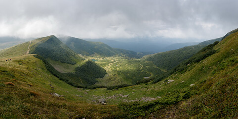 Panoramic view of the mountain range. Vacation in the mountains with a magnificent view. Valley high in the mountains.