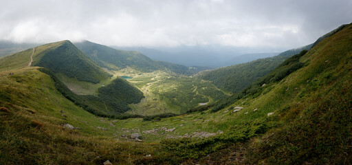 Panoramic view of the mountain range. Vacation in the mountains with a magnificent view. Valley high in the mountains.