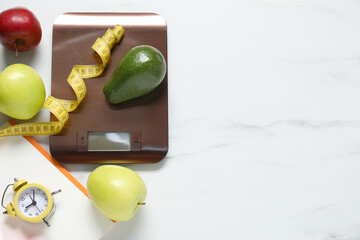 Electronic kitchen scale, measuring tape and products on white marble table, flat lay. Space for text