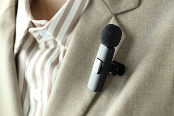 Woman with lavalier microphone on her shirt, closeup
