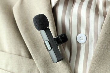 Woman with lavalier microphone on her shirt, closeup
