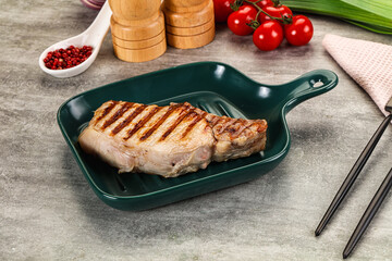 Grilled pork loin steak with bone
