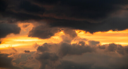 Beautiful bright orang sunset sky with dramatic clouds. Sunset sky background.