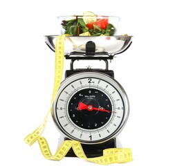 Kitchen scales with products and measuring tape isolated on white