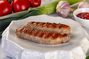 Grilled pork sausages served tomato sauce