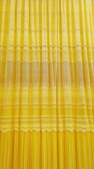Yellow lace curtains hanging in a window, filtering sunlight into a room, textured backdrop
