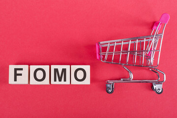 word FOMO cube wood on wooden table background. business concept
