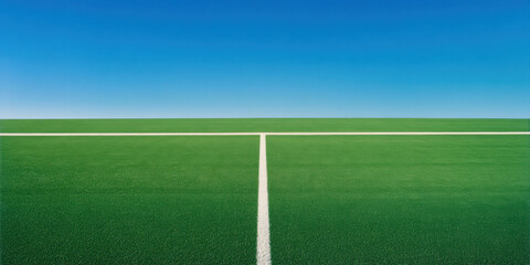 Fototapeta premium vibrant green football field clear blue sky creates serene and inviting atmosphere for sports enthusiasts. well maintained grass and crisp white lines enhance visual appeal, making it perfect