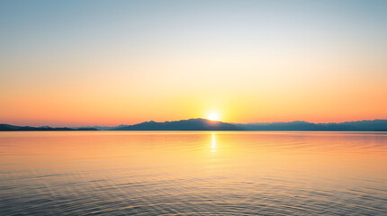 Naklejka premium A peaceful sunrise over a tranquil lake with mountains in the background, soft pastel colors in the sky