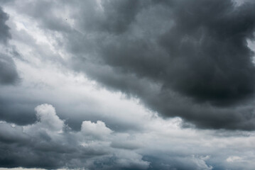 Obraz premium Dramatic dark storm thundercloud rain clouds on black sky background. Dark thunderstorm clouds rainny landscape. Meteorology danger windstorm disaster climate. Dark cloudscape storm disaster gray sky