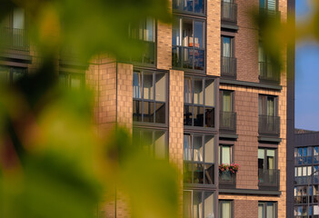 Fototapeta premium City view on a sunny day. Modern buildings, walls and windows. 