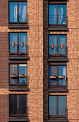 City view on a sunny day. Modern buildings, walls and windows. 