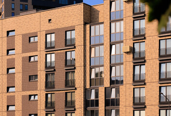 City view on a sunny day. Modern buildings, walls and windows. 