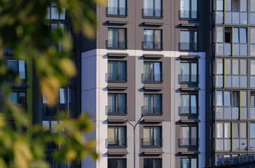 Fototapeta premium City view on a sunny day. Modern buildings, walls and windows. 
