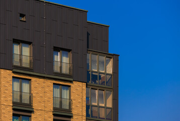 City view on a sunny day. Modern buildings, walls and windows. 