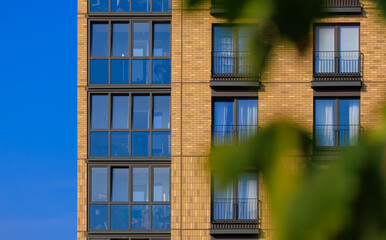 City view on a sunny day. Modern buildings, walls and windows. 