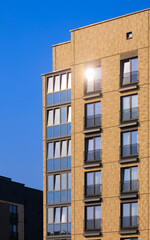 City view on a sunny day. Modern buildings, walls and windows. 
