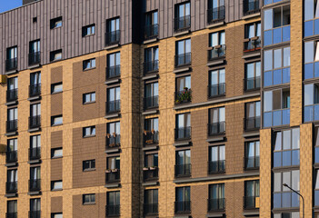 City view on a sunny day. Modern buildings, walls and windows. 