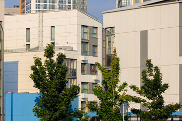 City view on a sunny day. Modern buildings, walls and windows. 