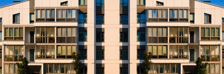 City view on a sunny day. Modern buildings, walls and windows. 