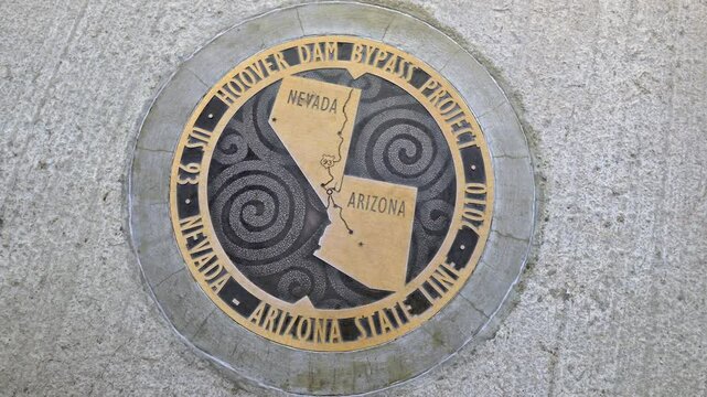 Bronze plaque marking the Arizona - Nevada state line, Hoover Dam, Arizona, Nevada, USA