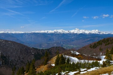 View of Triglav mountain peak covered in snow and municipality of Bohinj in Gorenjska, Slovenia