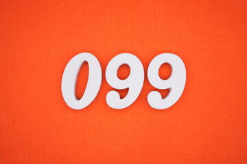 The numbers are made of white painted wood placed on an orange paper background.
