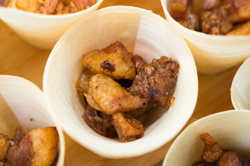 paper cone with pieces of meat to serve in the catering of a celebration.