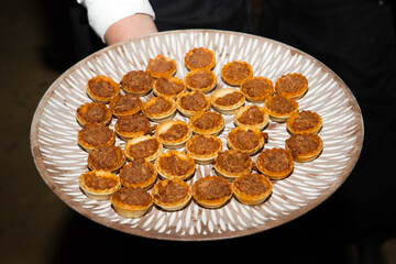 Canape of different flavors, fish, seafood, ham, meat, vegetables ready to serve in a catering service.