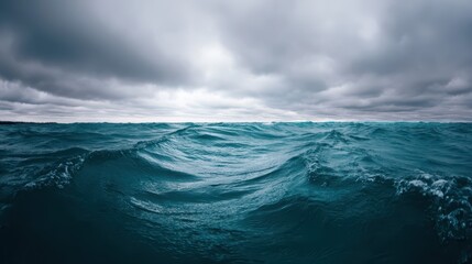 Fototapeta premium Raging waves surge and crash in a stormy sea, creating a chaotic atmosphere beneath a sky filled with dark, swirling clouds. The ocean's fury is evident in the turbulent waters