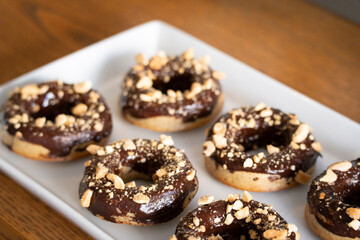 Healthy gluten-free donuts covered in chocolate and almonds, Mallorca, Balearic Islands, Spain