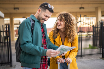 adult couple use map for navigation and explore on the train station © Miljan Živković