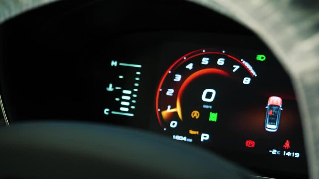 Arrow of tachometer in car shows number of engine revolutions per second. Tachometer of a new car with moving arrow on the gauge on dashboard, closeup view