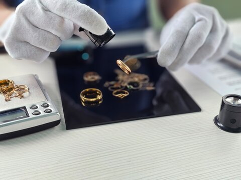 Jewelry appraisal process involving detailed examination of rings and other items