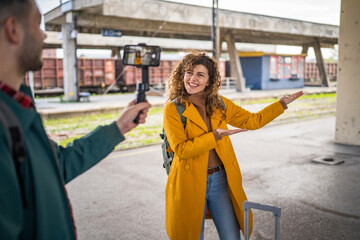 Fototapeta premium man record video on mobile phone of woman travel blog tourist
